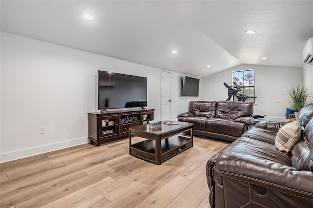 living room featuring a wall mounted AC, light hardwood / wood-style floors, and lofted ceiling