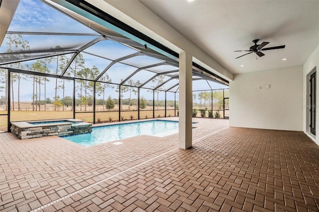 view of pool with an in ground hot tub, glass enclosure, ceiling fan, and a patio area