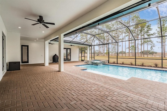 view of pool featuring french doors, ceiling fan, a lanai, an in ground hot tub, and a patio area