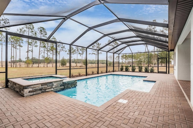 view of swimming pool with an in ground hot tub, glass enclosure, and a patio area