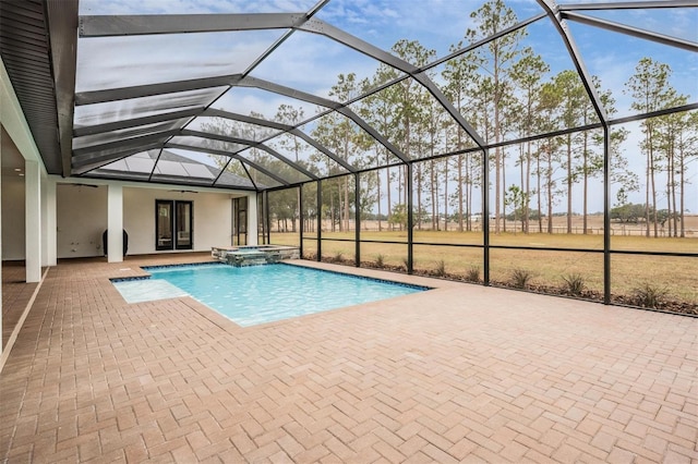 view of pool featuring a patio area, a lanai, and an in ground hot tub