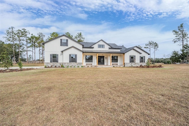 modern farmhouse featuring a front yard and covered porch