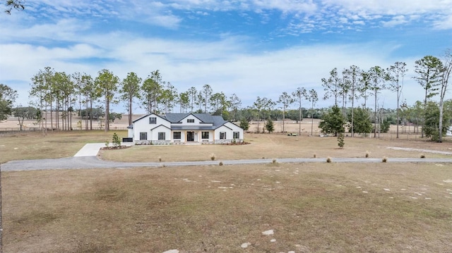 view of front facade featuring a rural view