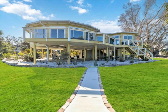 rear view of house with a deck and a yard