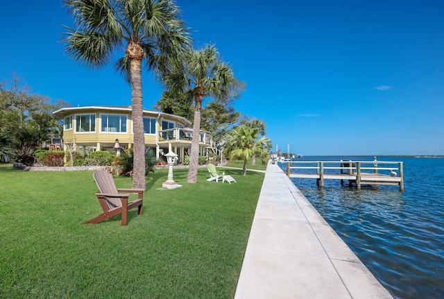 dock area featuring a water view and a lawn