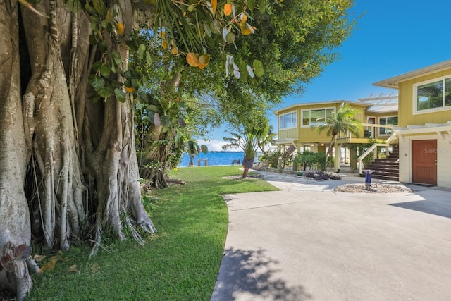 exterior space featuring a water view, a yard, and a patio