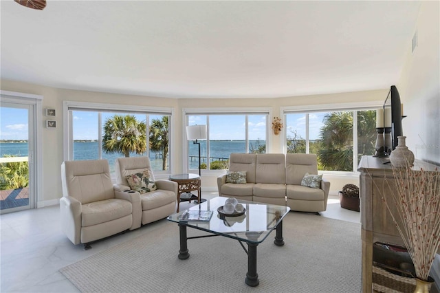 living room featuring a wealth of natural light and a water view