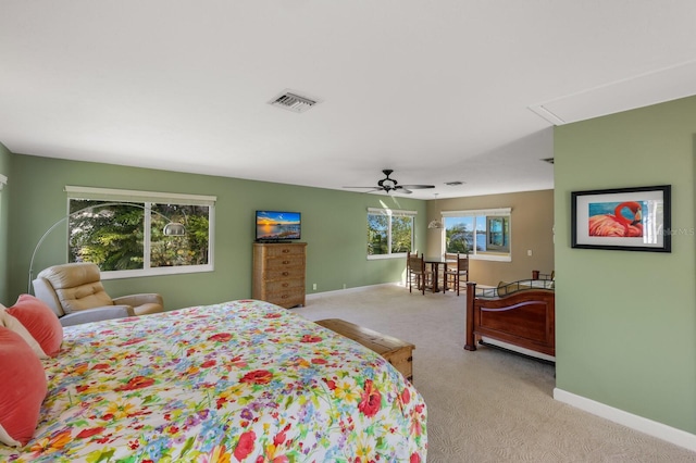 bedroom with ceiling fan and light colored carpet