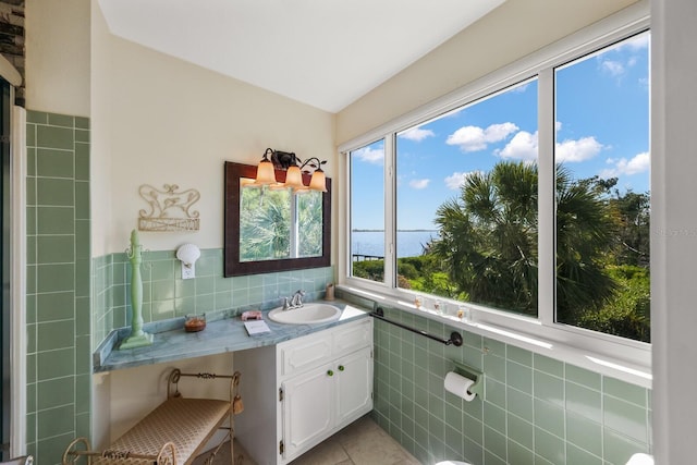 bathroom featuring tile walls, tile patterned flooring, and vanity