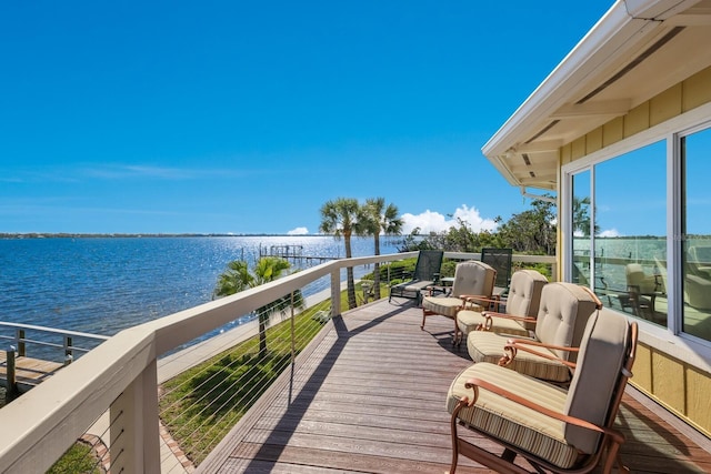 wooden deck featuring a water view