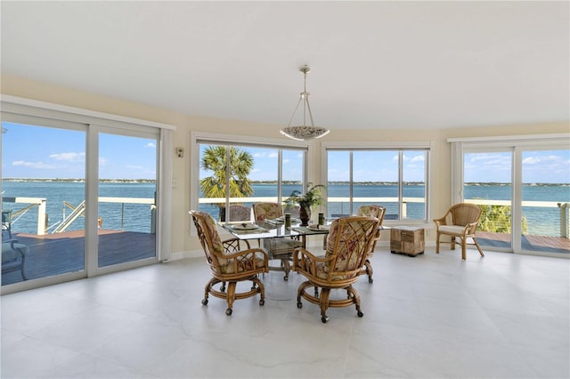 interior space with a water view and a chandelier