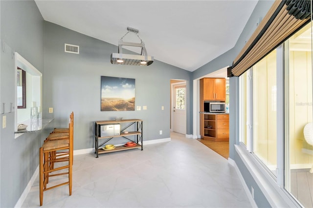 dining area featuring vaulted ceiling