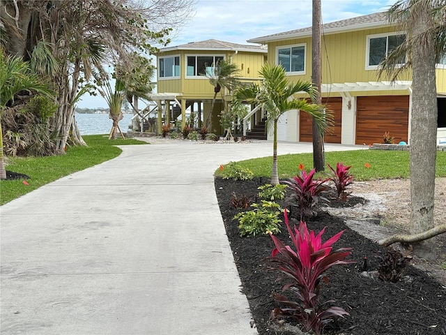 coastal home with a water view and a garage