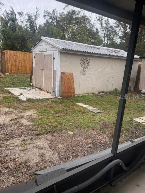 view of outbuilding featuring a lawn