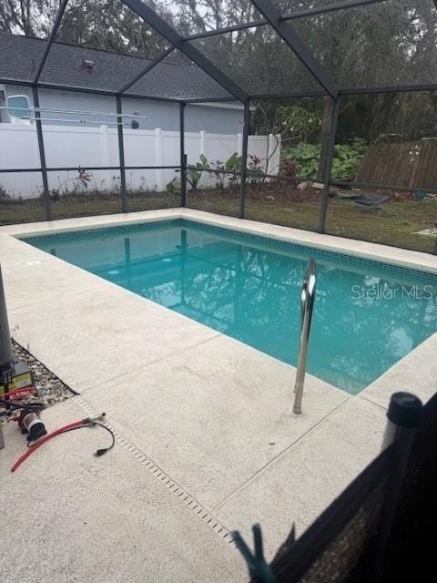 view of pool with a lanai and a patio