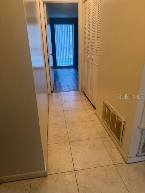 corridor with light tile patterned floors