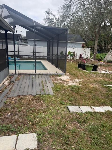 exterior space featuring a fenced in pool and a lanai