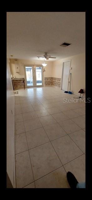 spare room featuring ceiling fan and light tile patterned floors