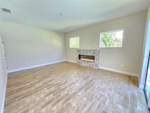 unfurnished living room with light hardwood / wood-style floors and a fireplace