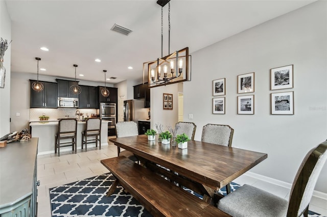 dining room with light tile patterned floors and a chandelier