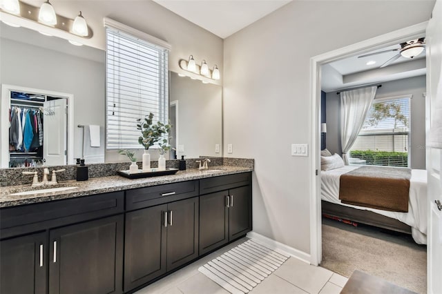 bathroom with tile patterned floors, ceiling fan, vanity, and a healthy amount of sunlight