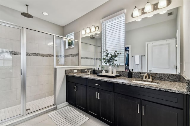 bathroom with tile patterned flooring, vanity, and an enclosed shower