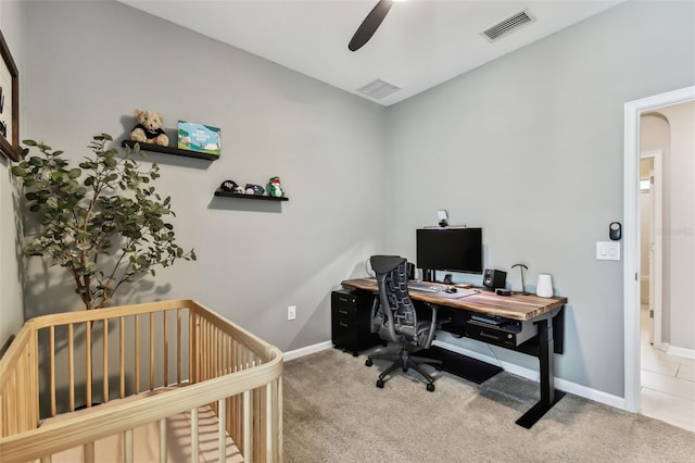 carpeted home office with ceiling fan