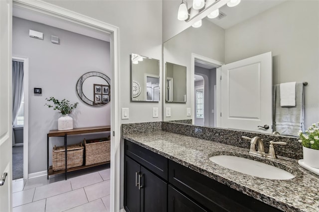 bathroom featuring tile patterned flooring, vanity, and plenty of natural light