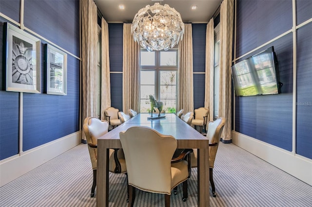 dining room with carpet flooring and a notable chandelier