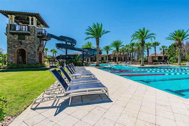 view of swimming pool featuring a yard and a patio area