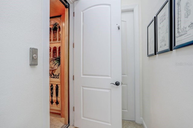 hallway featuring light tile patterned flooring