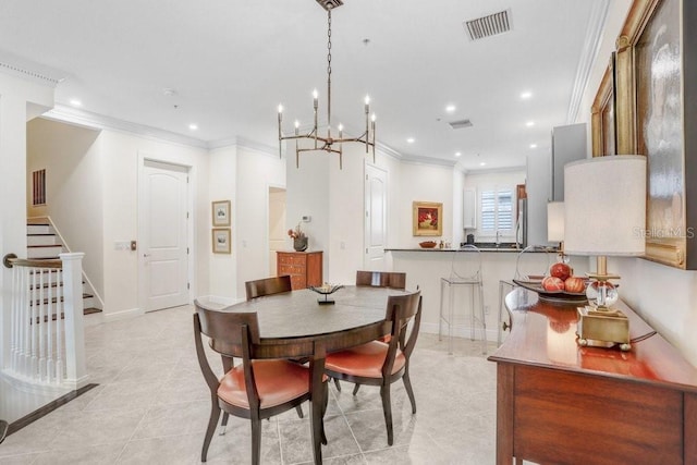 tiled dining room featuring an inviting chandelier and ornamental molding