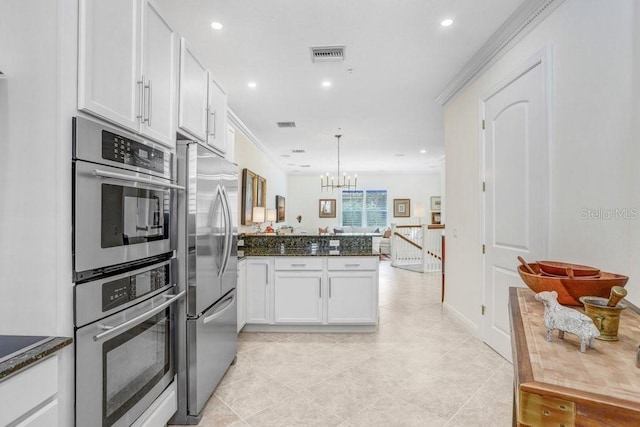 kitchen featuring pendant lighting, crown molding, white cabinetry, and stainless steel appliances