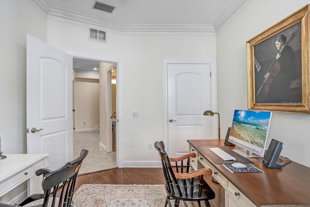 office area with light wood-type flooring and ornamental molding