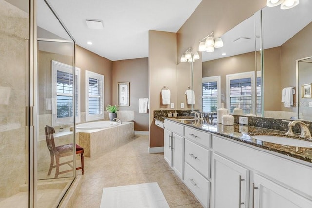 bathroom with tile patterned floors, vanity, a healthy amount of sunlight, and independent shower and bath