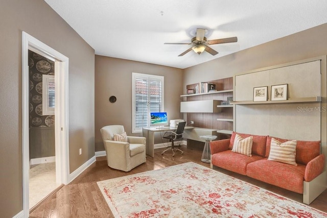 living room featuring hardwood / wood-style floors and ceiling fan