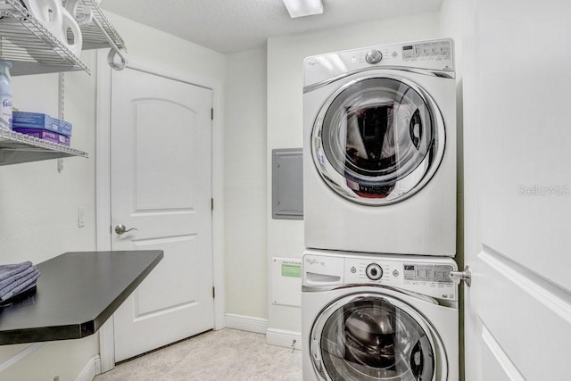 laundry room featuring stacked washer and dryer