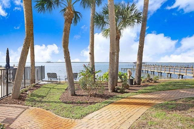 view of yard featuring a boat dock and a water view