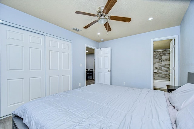 bedroom with a textured ceiling, a closet, ceiling fan, and hardwood / wood-style flooring