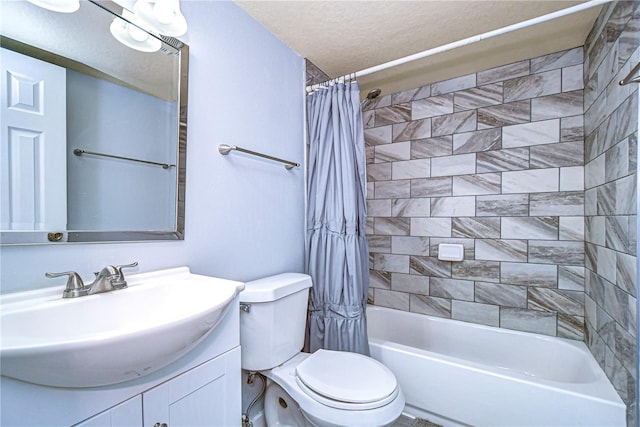 full bathroom with shower / bath combination with curtain, toilet, a textured ceiling, and vanity