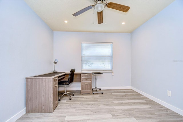 unfurnished office featuring ceiling fan and light hardwood / wood-style floors