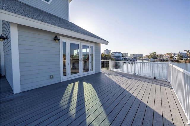 wooden deck featuring french doors and a water view