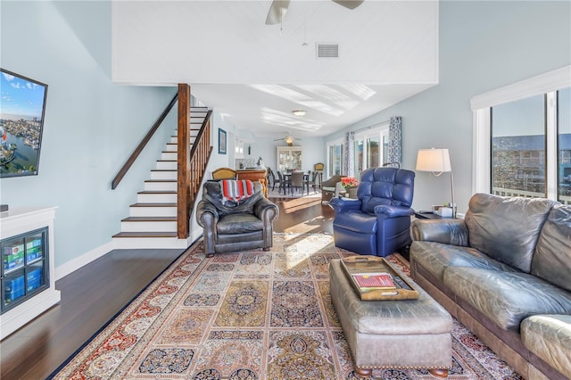 living room featuring wood-type flooring and ceiling fan