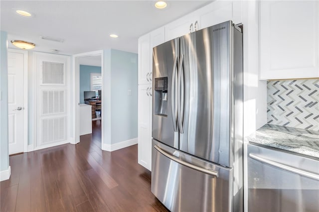 kitchen with white cabinets, dark hardwood / wood-style floors, light stone countertops, tasteful backsplash, and stainless steel fridge with ice dispenser