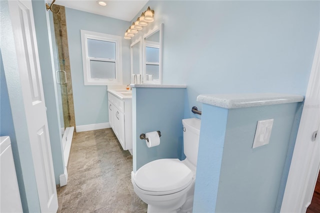 bathroom with vanity, toilet, and walk in shower