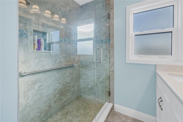 bathroom featuring vanity and a shower with shower door