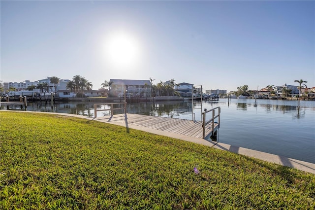 view of dock featuring a yard and a water view