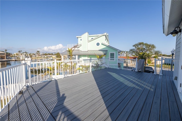 wooden terrace featuring a water view