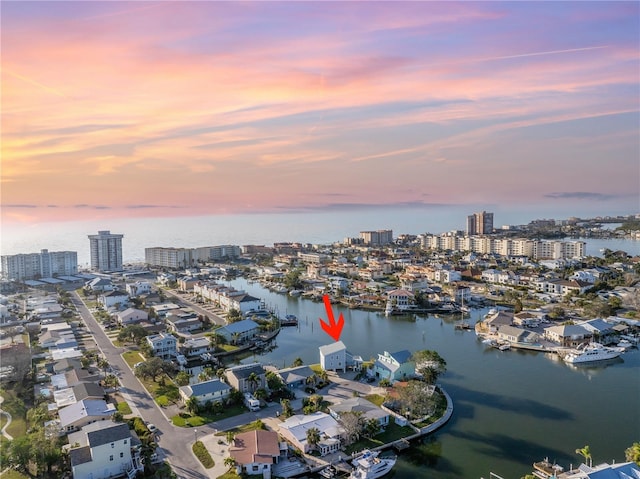 aerial view at dusk with a water view