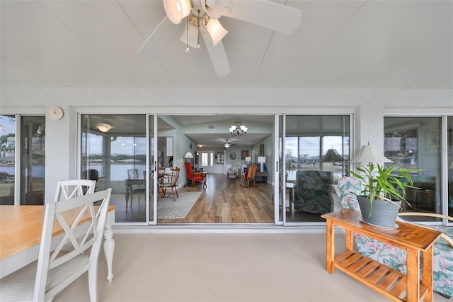 sunroom / solarium featuring plenty of natural light and ceiling fan with notable chandelier